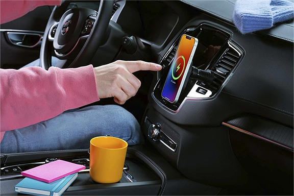 Mobile phone is charging in a MagSafe vehicle holder, attached to the air vents.